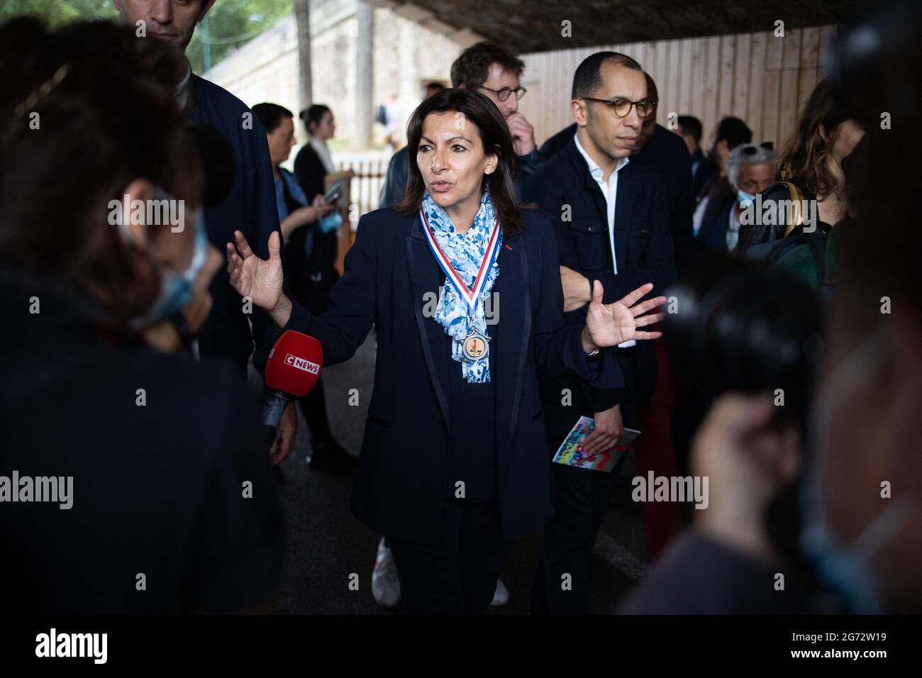 Mayor of Paris Anne Hidalgo wear a medal given by a man as she walks on the Seine docks as she launches the 2021 edition of the Paris Plage ( Paris Beach ) on the dock of the Seine in Paris, France on July 10, 2021. Photo by Raphael Lafargue/ABACAPRESS.COM Stock Photo