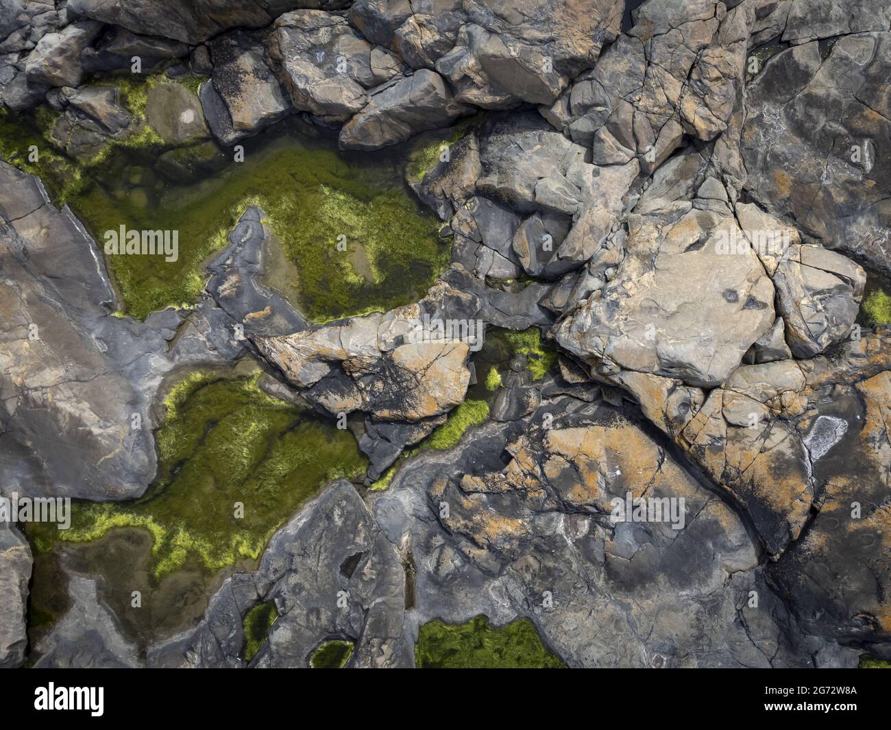 Overhead shot of a landscape with big rocks and small lawns with green ...