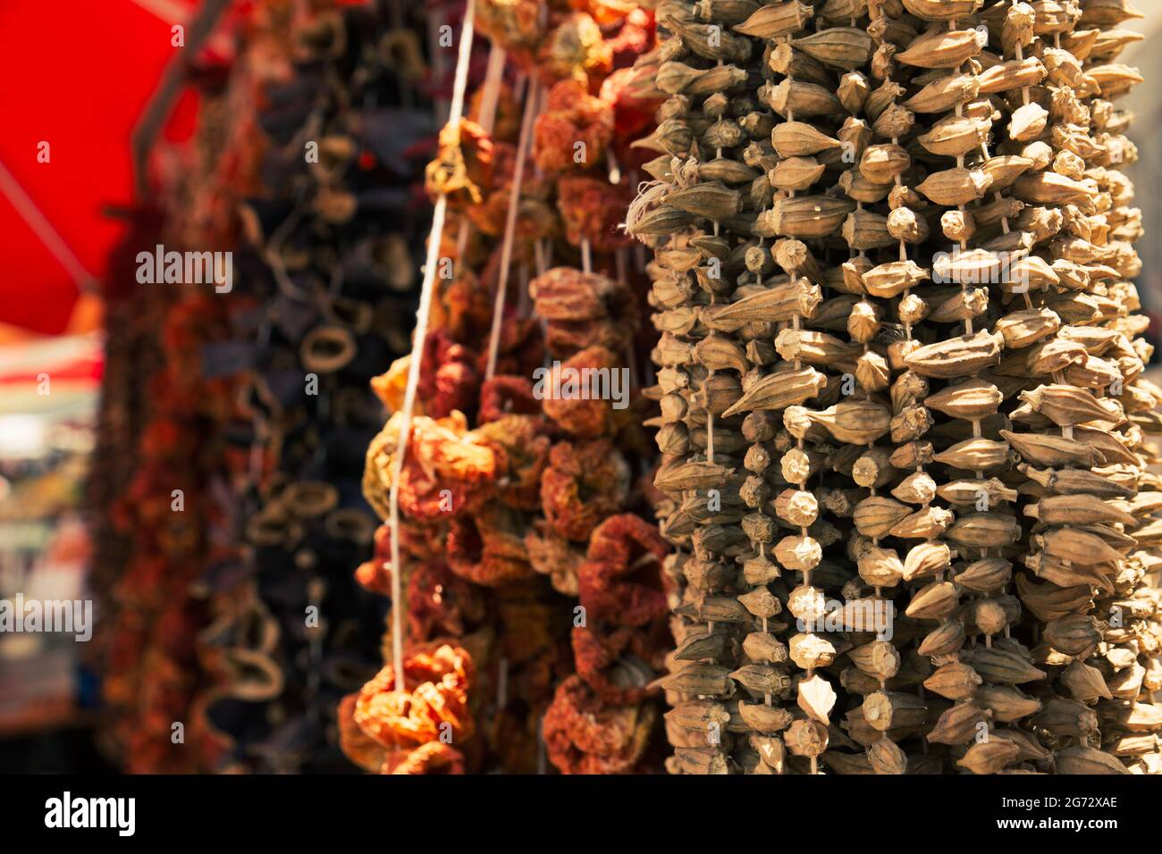 Dried okras and other vegetables in display under natural sunlight, outdoors. Stock Photo