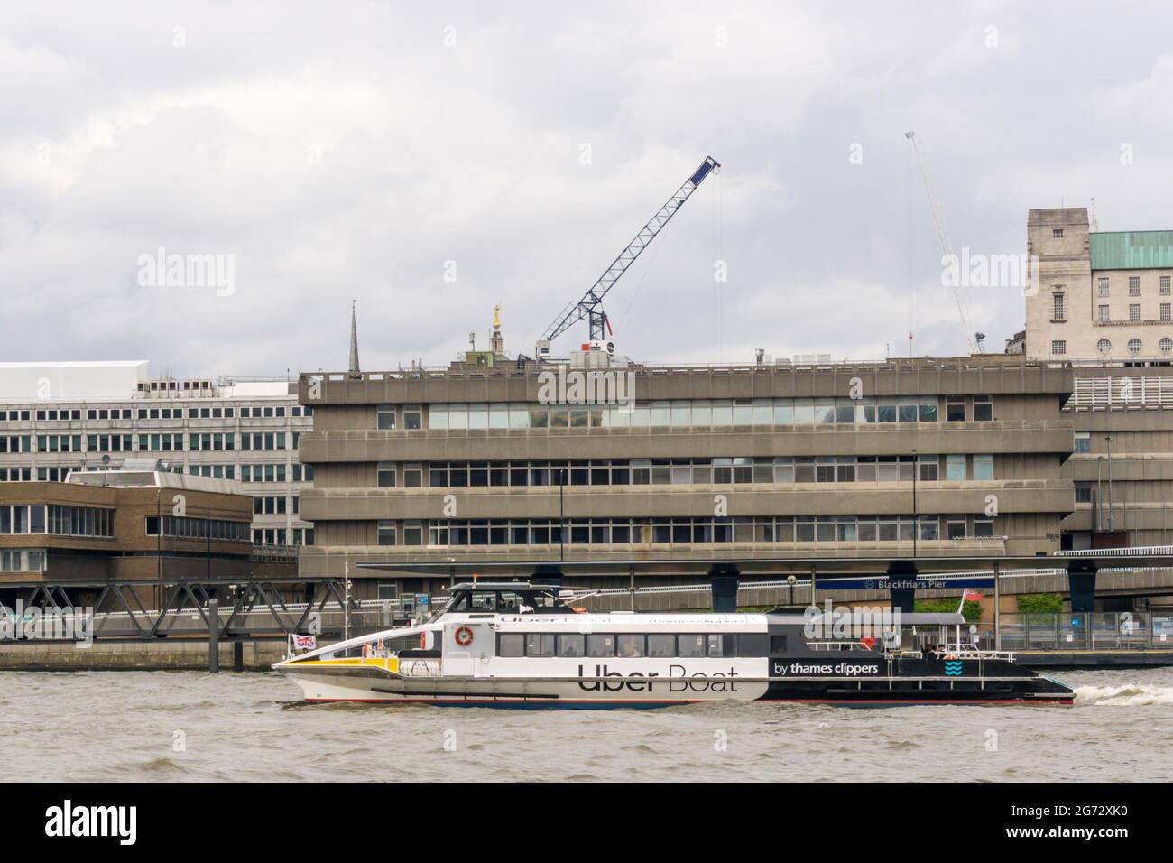 A Thames Clippers Uber Boat passing Blackfriars Pier on the River Thames, London. Stock Photo