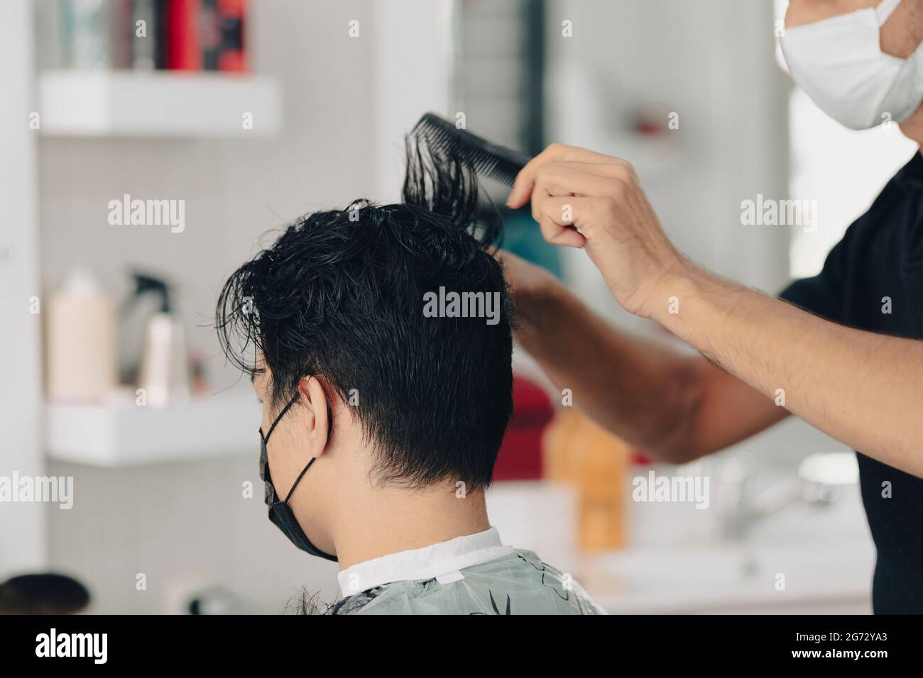 Haircut at a men's barbershop.Haircut with scissors Stock Photo