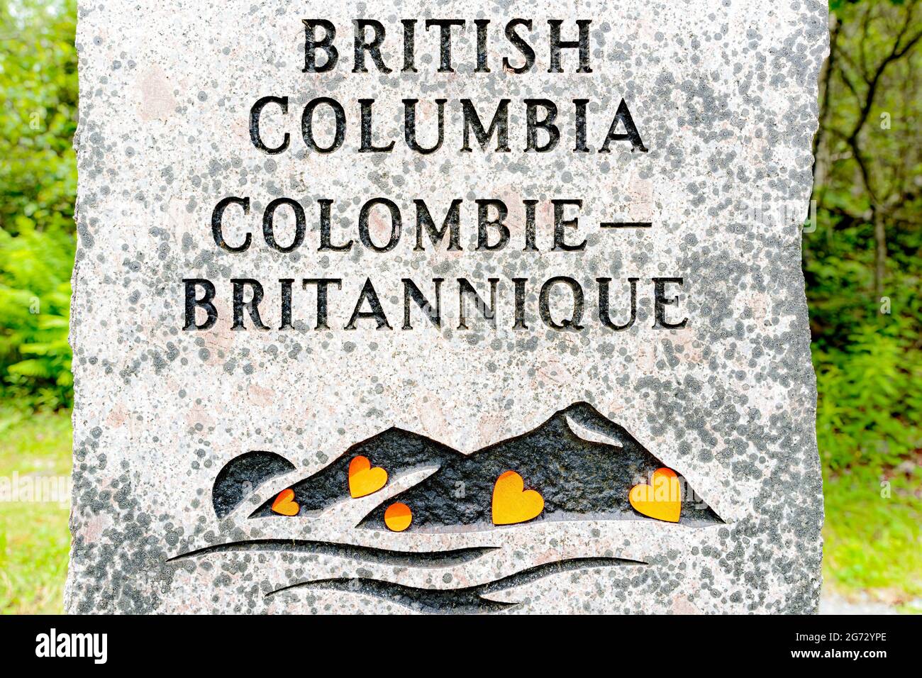 Saint John, NB, Canada - July 1, 2021: Orange hearts on the British Columbia stone in memory of Indigenous children who died in residential schools. Stock Photo