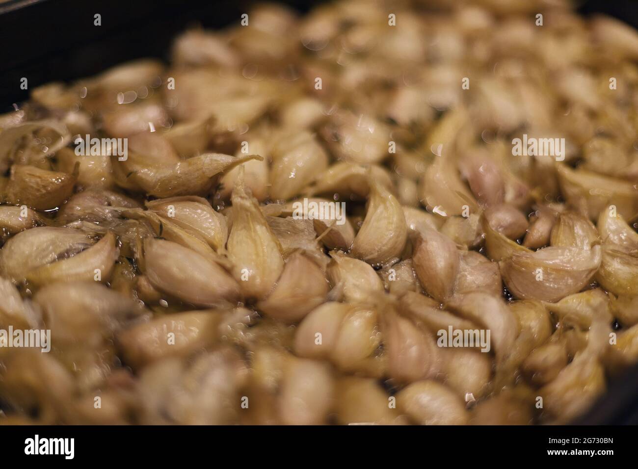 garlic cloves confit in olive oil Stock Photo Alamy