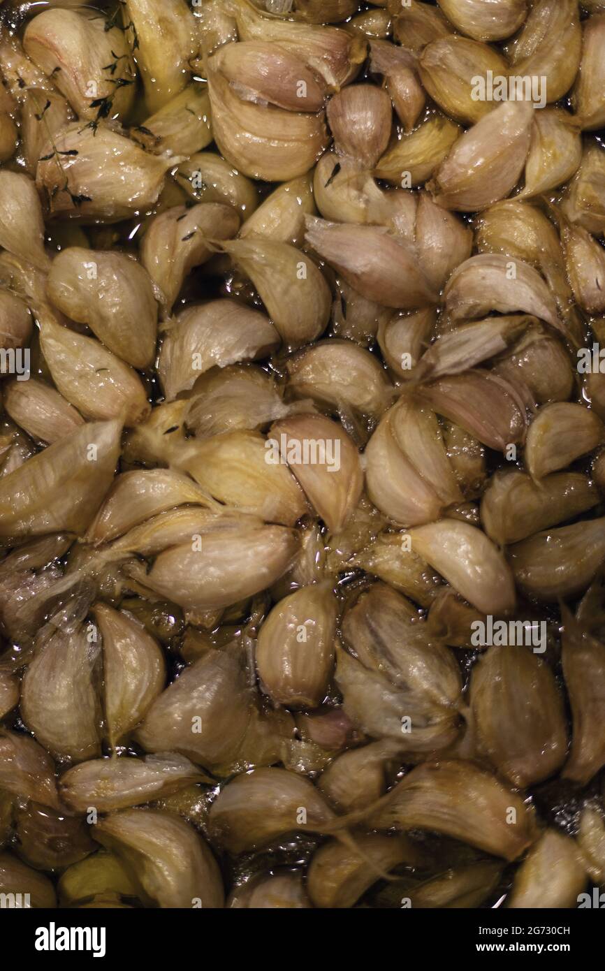 garlic cloves confit in olive oil Stock Photo Alamy