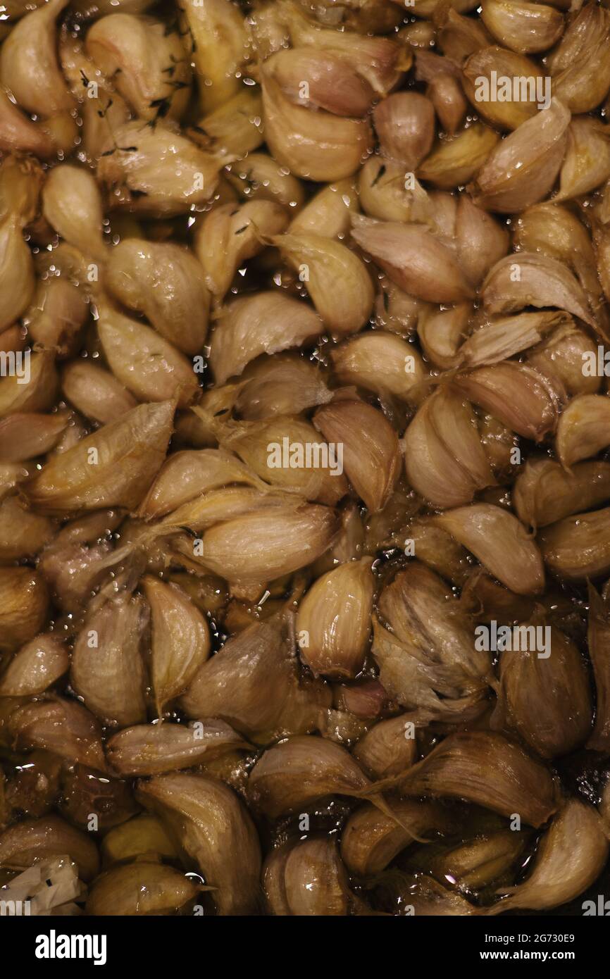 garlic cloves confit in olive oil Stock Photo Alamy