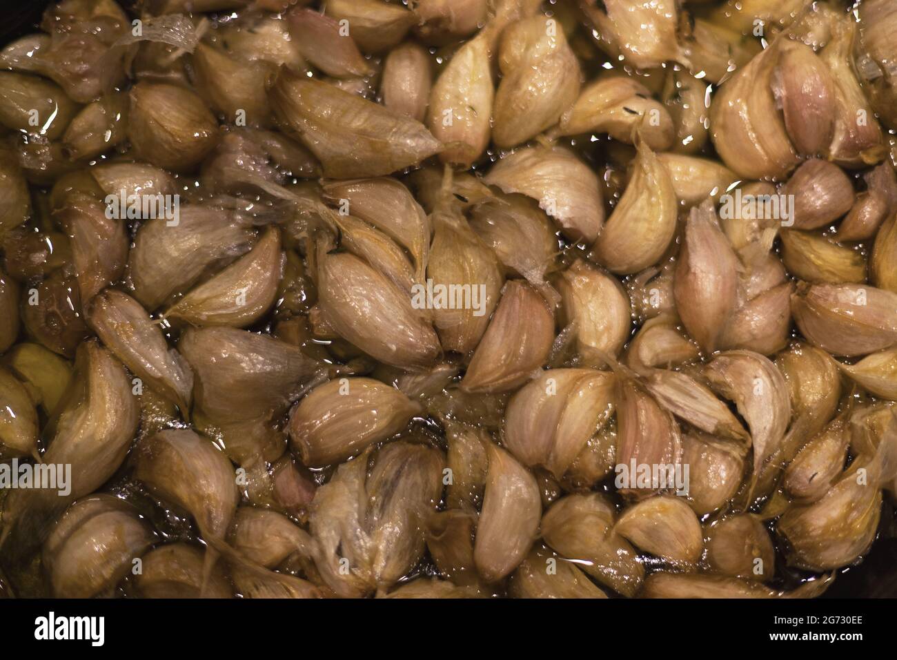 garlic cloves confit in olive oil Stock Photo Alamy