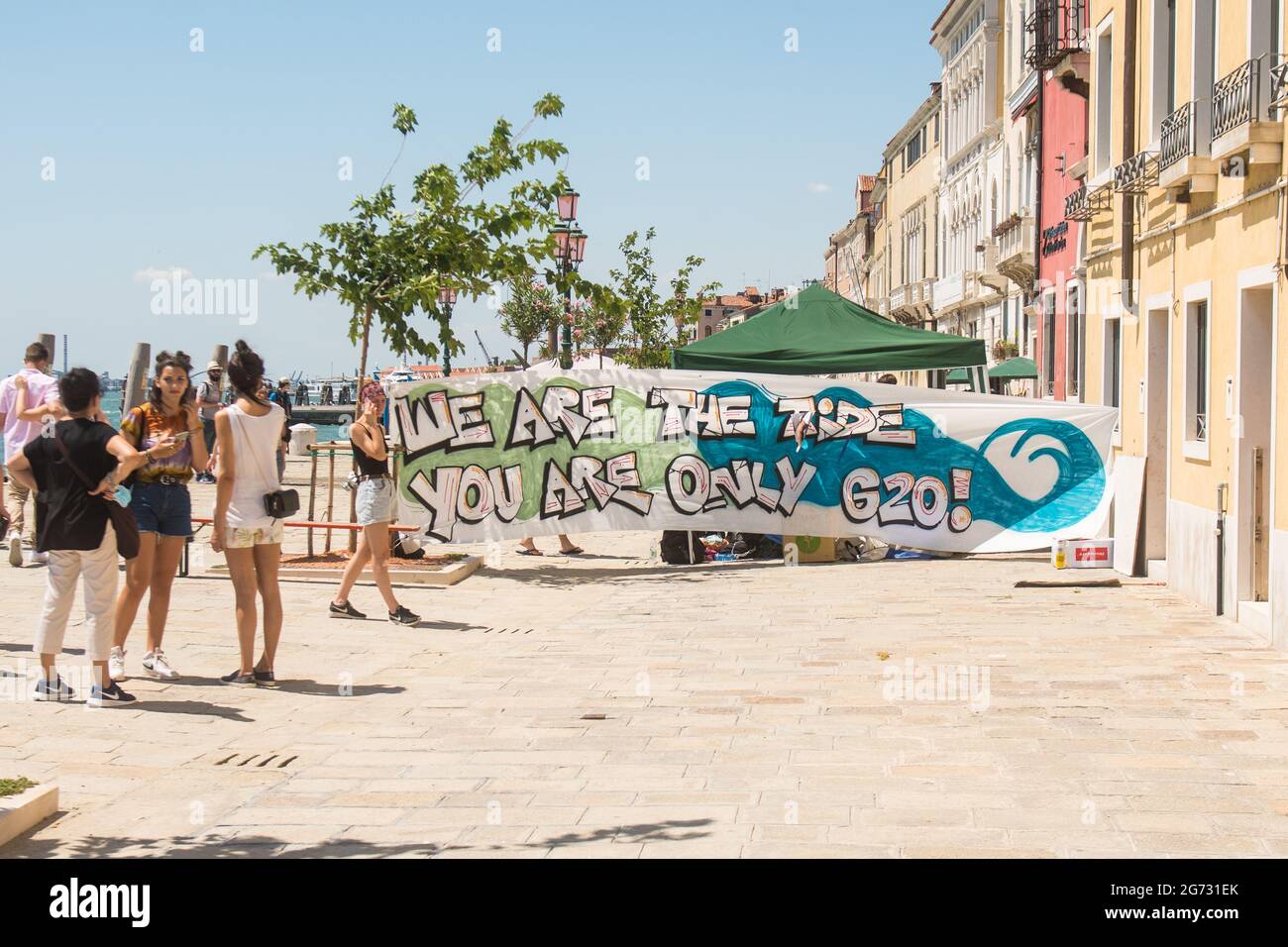 Venice, Italy. 10th July, 2021. Protestors wait ahead the demonstration 'We are the tide, you are only (G)20' on July 10, 2021 in Venice, Italy. For their third meeting under the Italian G20 presidency, on 9 and 10 July 2021, G20 Finance Ministers and Central Bank Governors (FMCBG) gathered in Venice for a two-day summit on issues related to global economy and health © Simone Padovani / Awakening / Alamy Live News Stock Photo