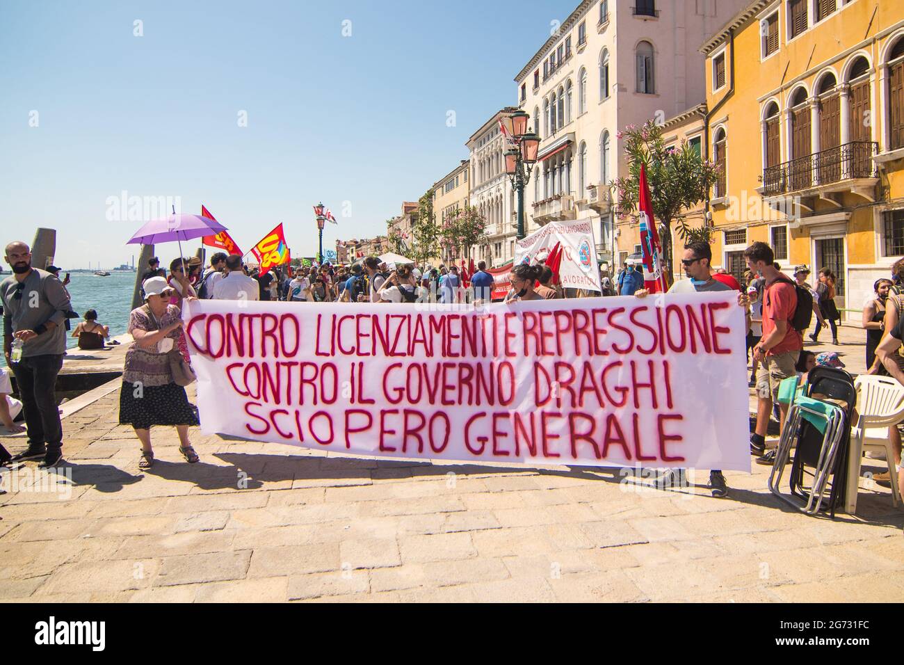 Venice, Italy. 10th July, 2021. Protestors at the demonstration 'We are the tide, you are only (G)20' on July 10, 2021 in Venice, Italy. For their third meeting under the Italian G20 presidency, on 9 and 10 July 2021, G20 Finance Ministers and Central Bank Governors (FMCBG) gathered in Venice for a two-day summit on issues related to global economy and health © Simone Padovani / Awakening / Alamy Live News Stock Photo
