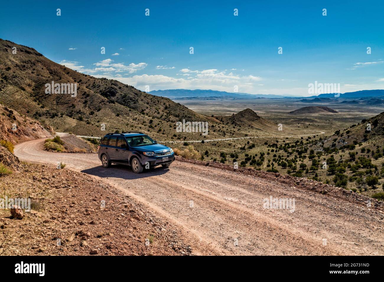 SUV at Pony Express Trail, Back Country Byway, view from Dugway Pass in Dugway Range, Great Basin, Utah, USA Stock Photo
