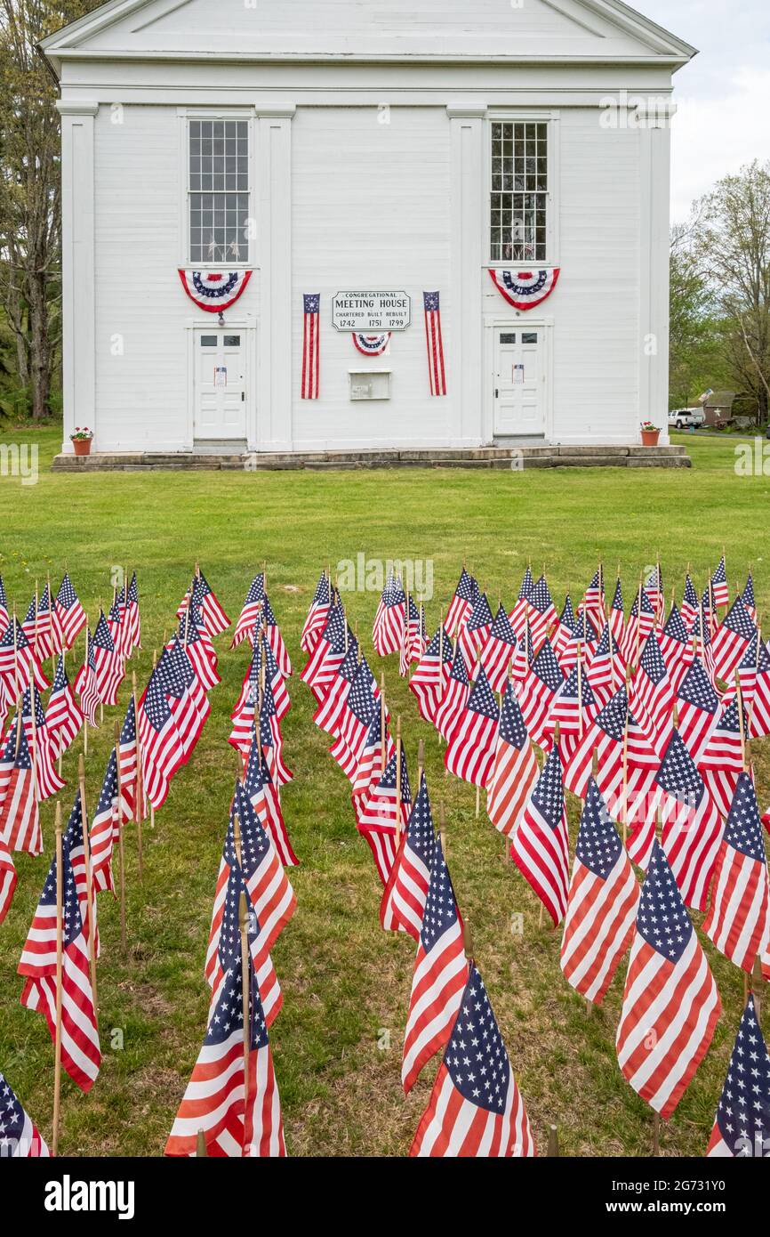 American flags adorn the the grass in front of the Ware Historical Society in honor of Memorial Day Stock Photo