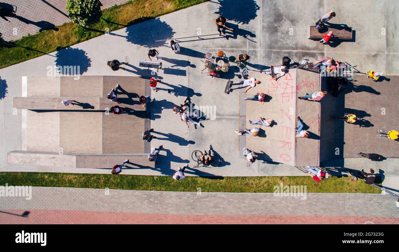 Young people dancing, singing and playing sports on the city s waterfront, aerial shooting from drone Stock Photo