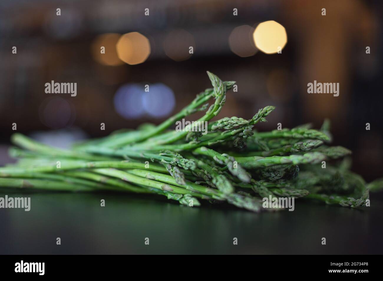 Green fresh asparagus on blurred background Stock Photo