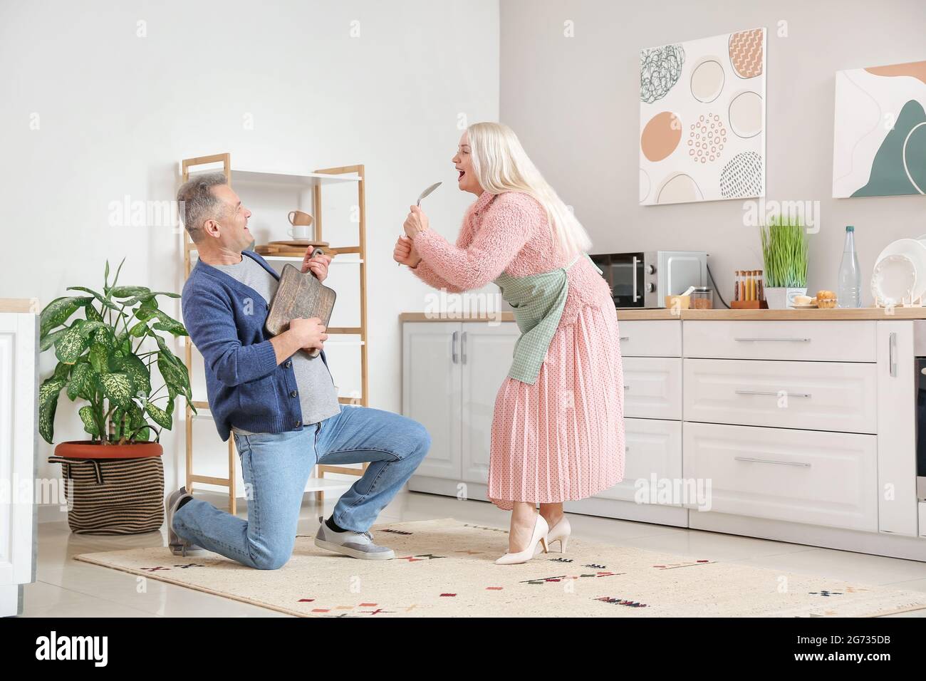 Happy mature couple dancing at home Stock Photo