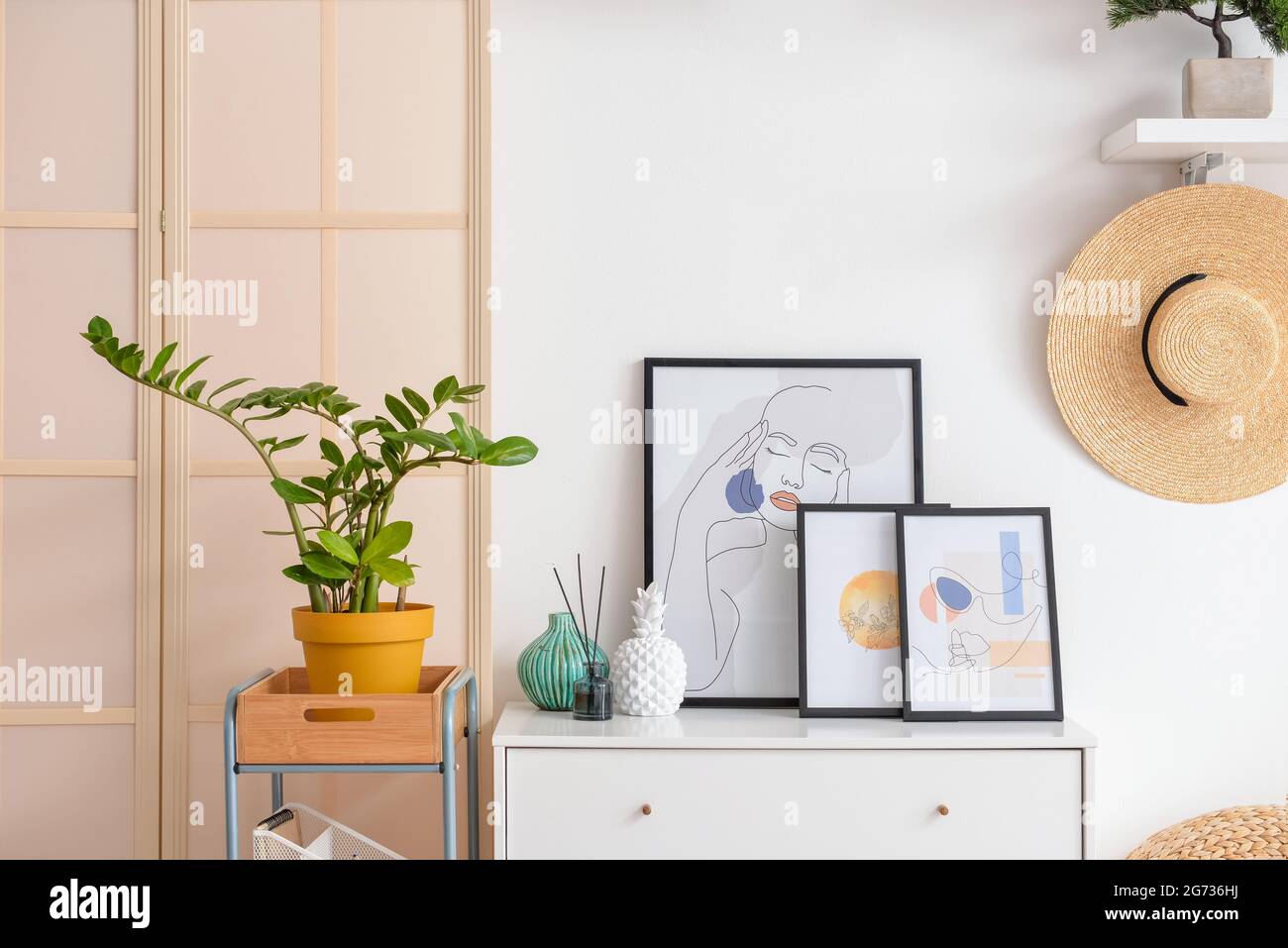 Interior of stylish living room with pictures Stock Photo - Alamy