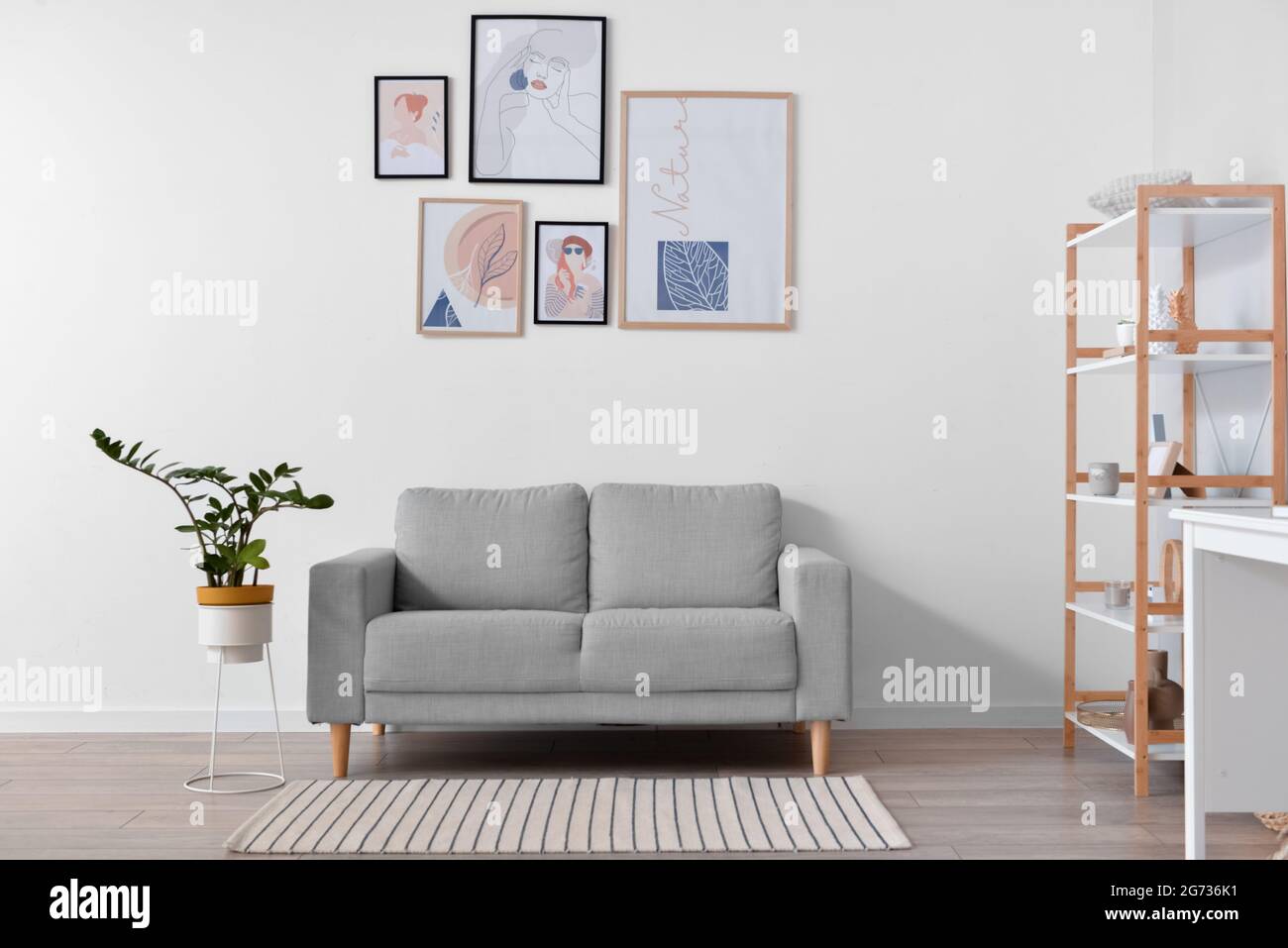 Interior of stylish living room with pictures Stock Photo - Alamy