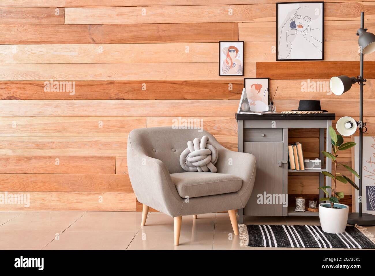 Interior of stylish living room with pictures Stock Photo - Alamy