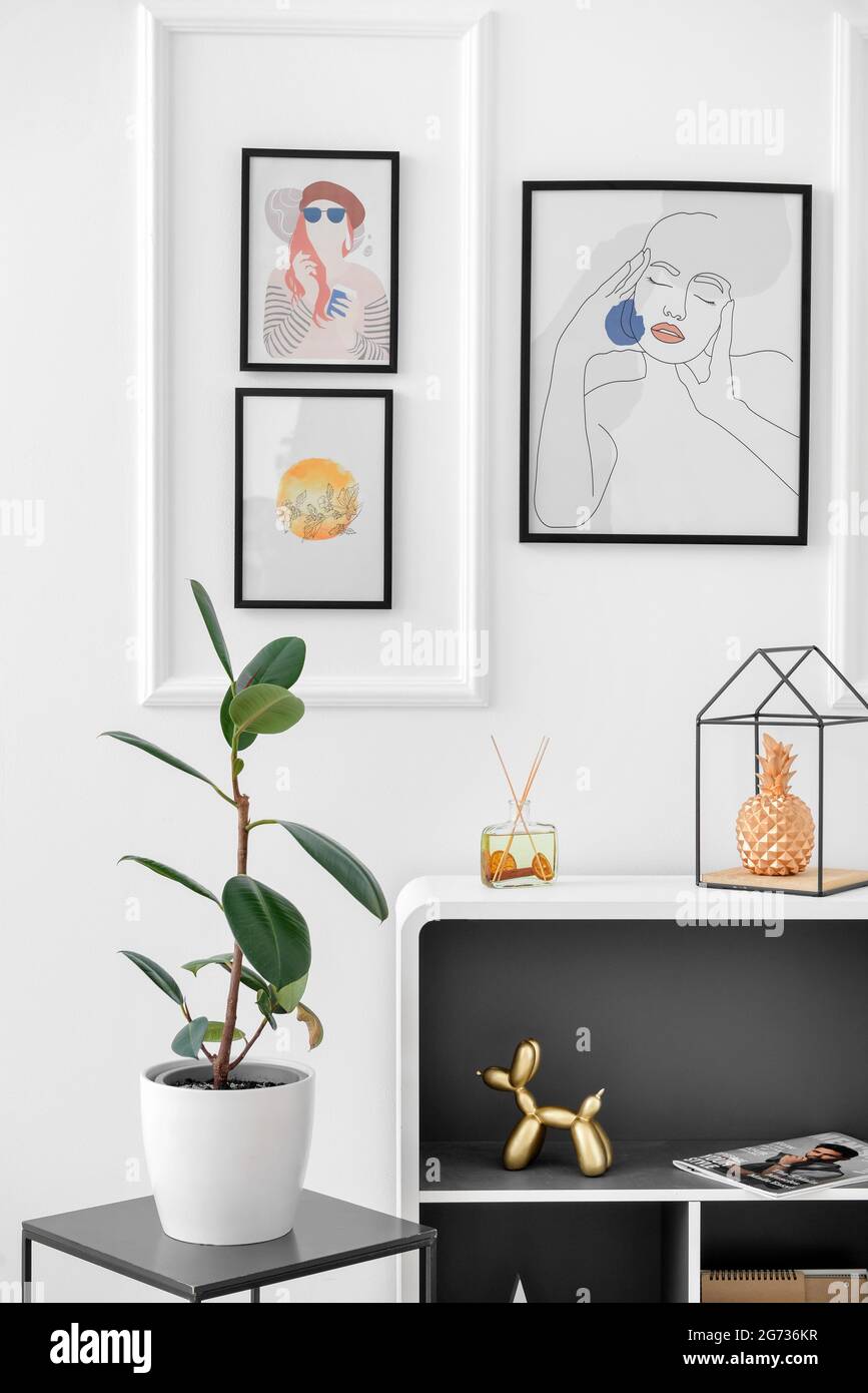 Interior of stylish living room with pictures Stock Photo - Alamy