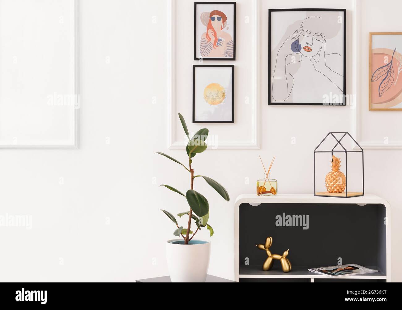 Interior of stylish living room with pictures Stock Photo - Alamy
