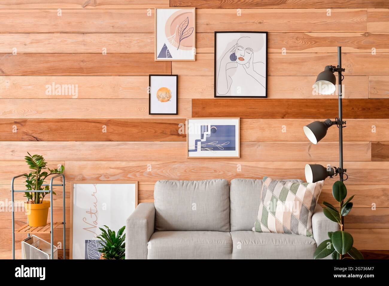 Interior of stylish living room with pictures Stock Photo - Alamy
