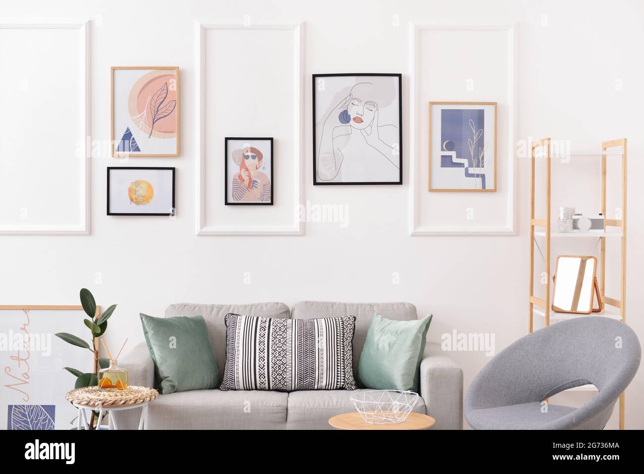 Interior of stylish living room with pictures Stock Photo - Alamy