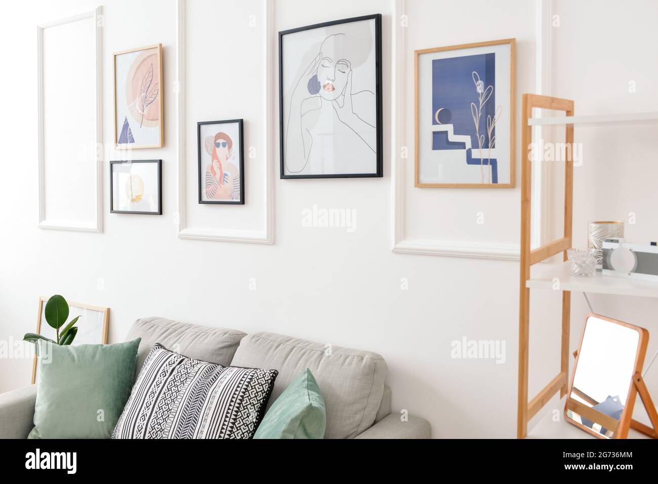 Interior of stylish living room with pictures Stock Photo - Alamy