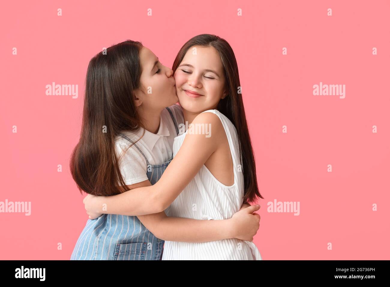 portrait-happy-twin-girls-kissing-hi-res-stock-photography-and-images