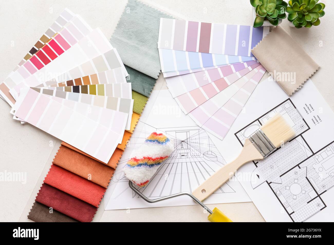 Composition with paint color palettes and fabric samples on white ...