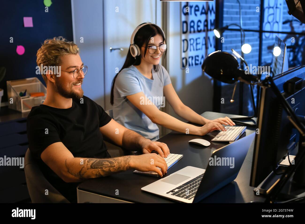 Young programmers working with computer in office at night Stock Photo