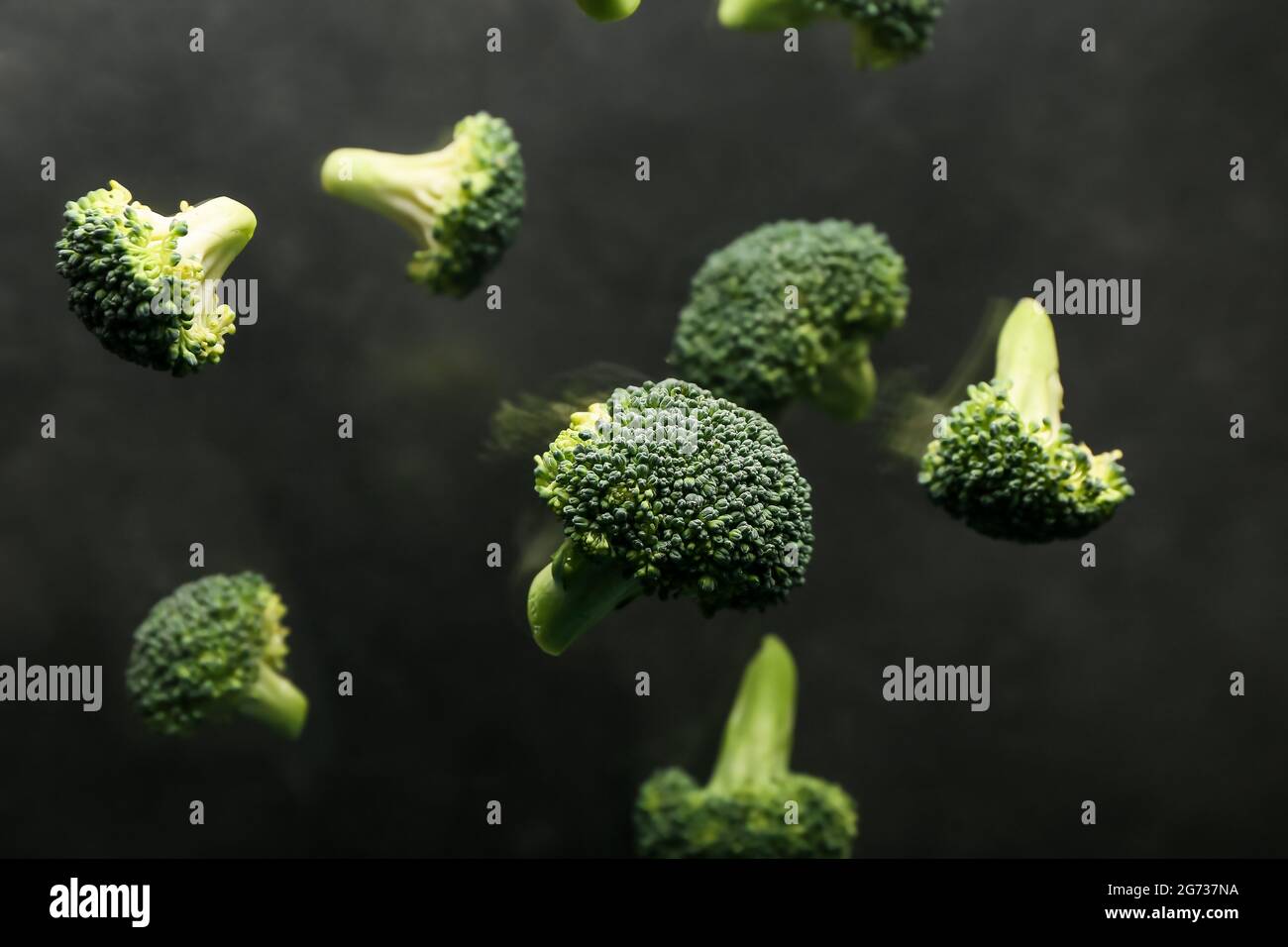 Flying broccoli cabbage on dark background Stock Photo - Alamy