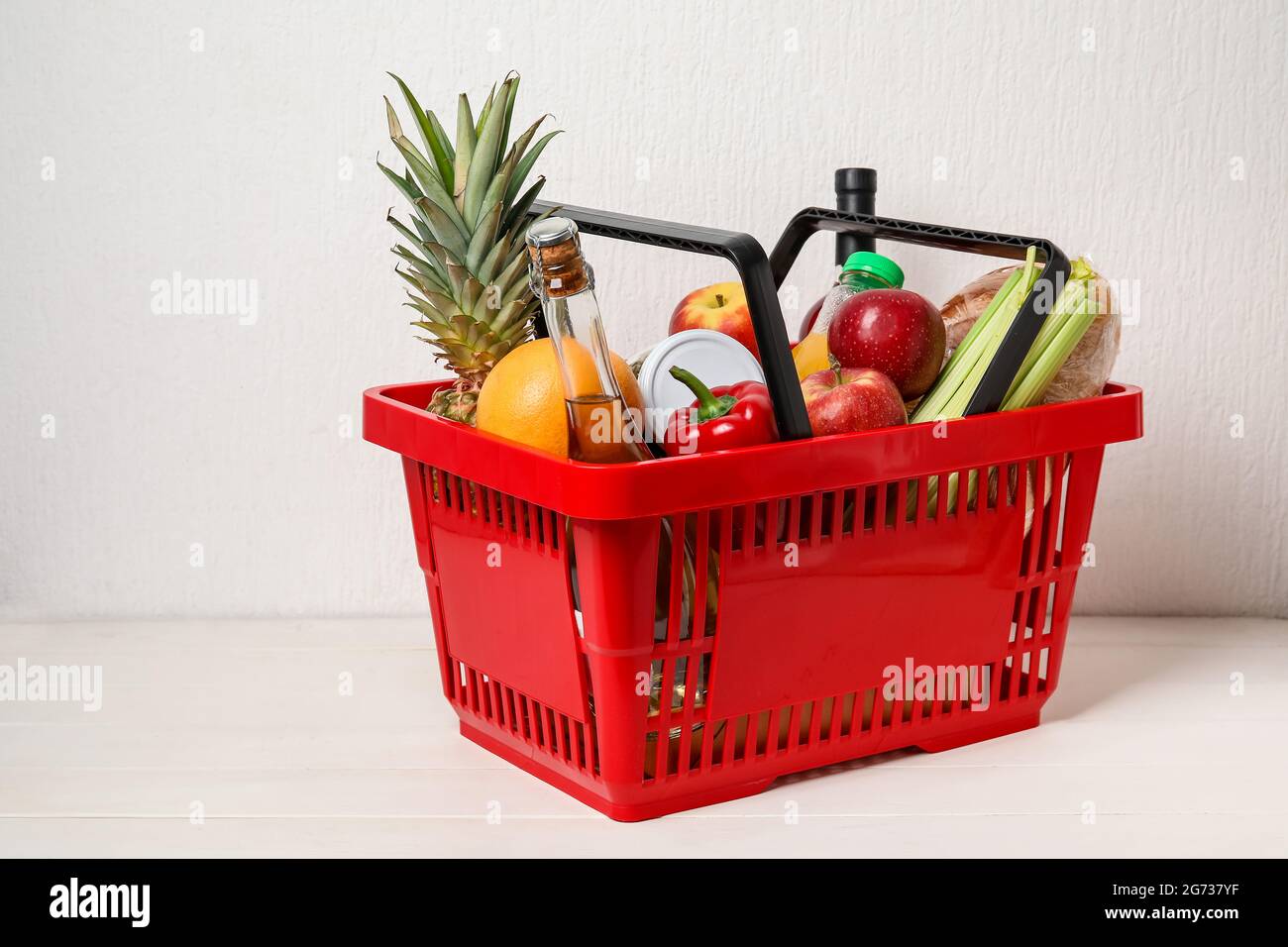 Shopping basket with food on white background Stock Photo