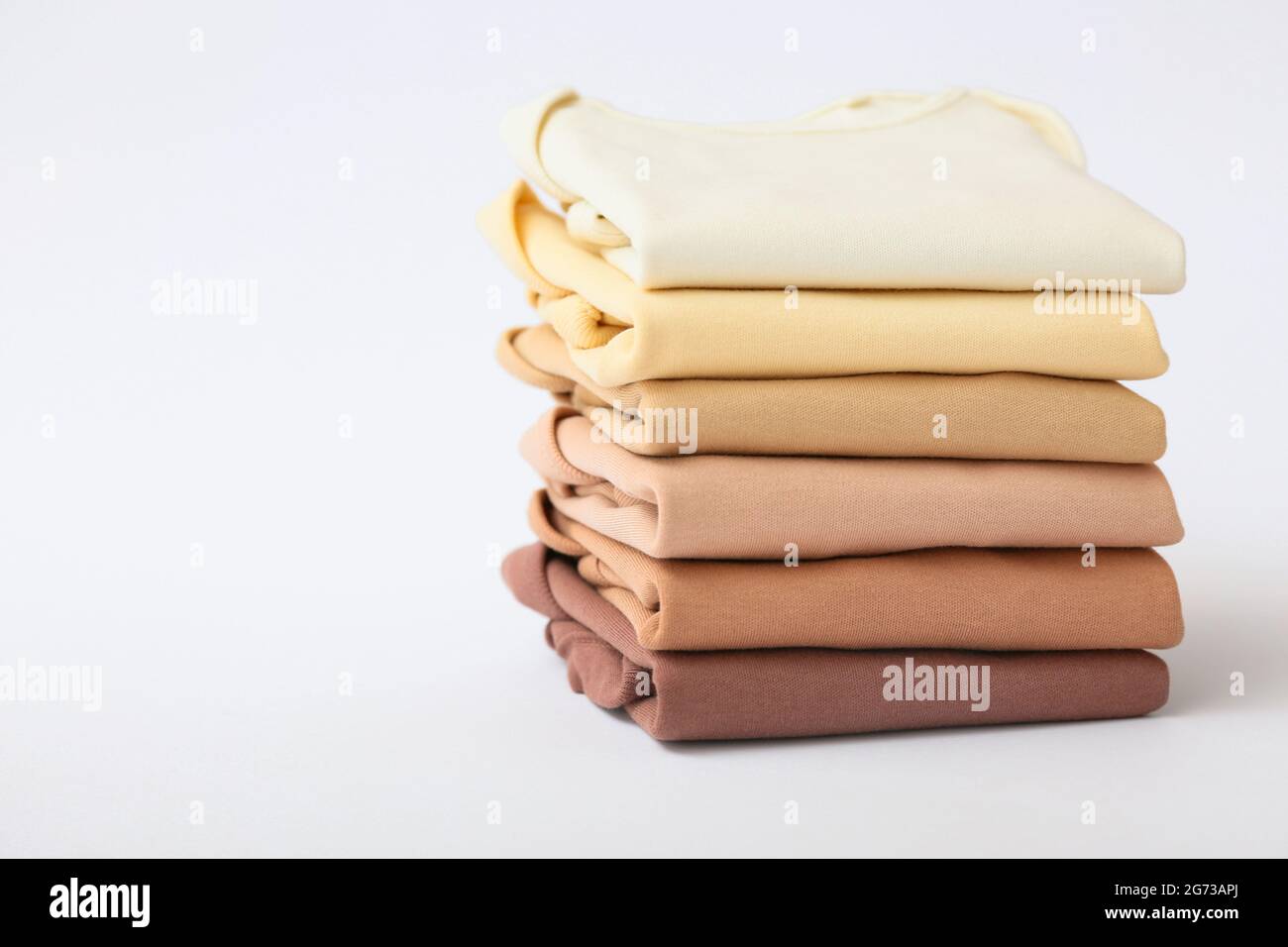 Stack of baby clothes on grey background Stock Photo - Alamy