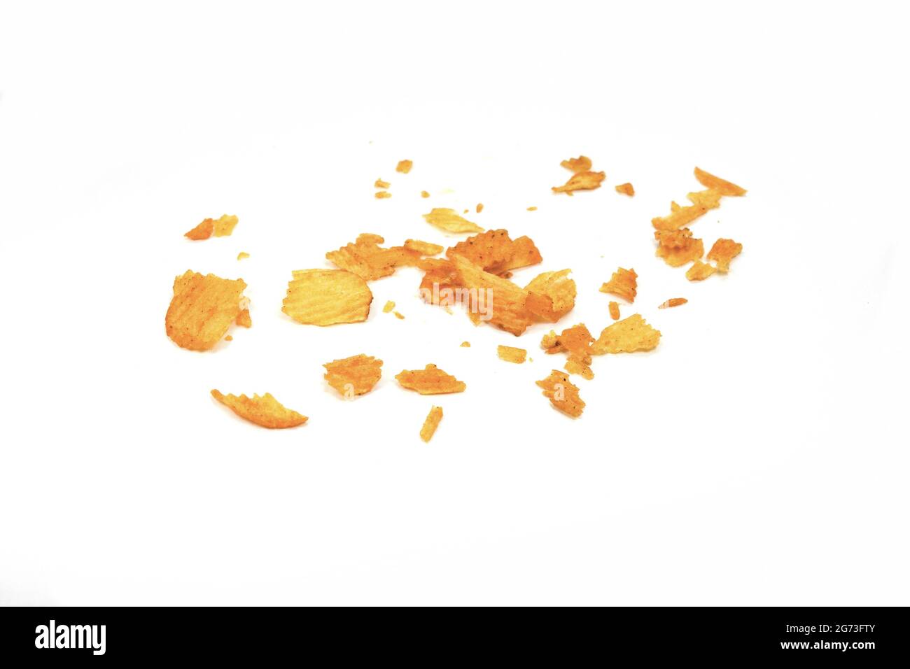 Potato chips crumbs and leftovers isolated over the white background