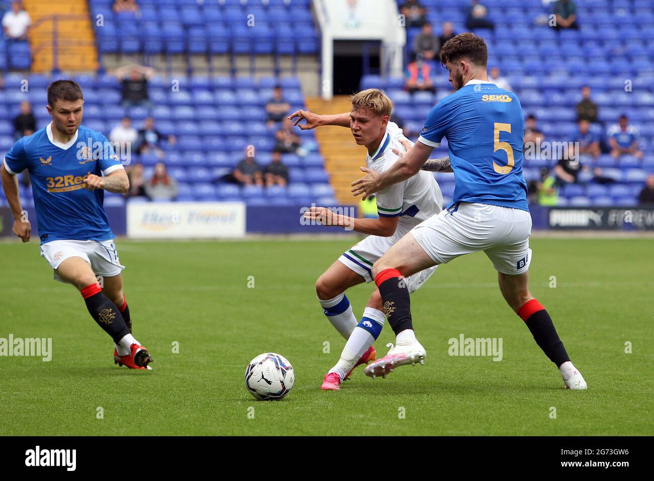 Birkenhead, UK. 10th July, 2021. Paul Glatzel of Tranmere Rovers plays the ball past Jack Simpson of Rangers during the Pre-Season Friendly match between Tranmere Rovers and Rangers at Prenton Park on July 10th 2021 in Birkenhead, England. (Photo by Richard Ault/phcimages.com) Credit: PHC Images/Alamy Live News Stock Photo
