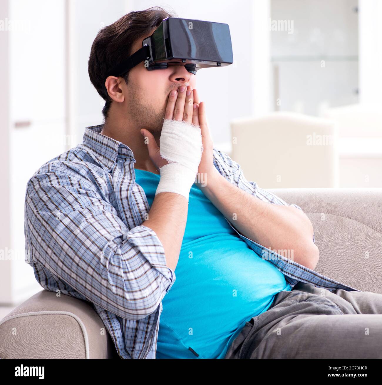 The man with hand injury wearing virtual reality glasses Stock Photo