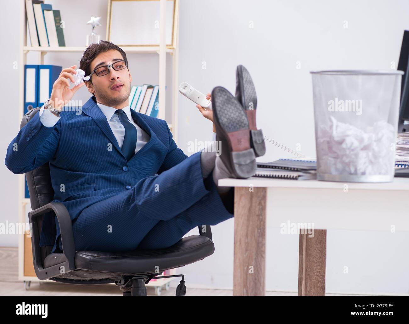 Young handsome businessman employee working in office in paperwork concept Stock Photo