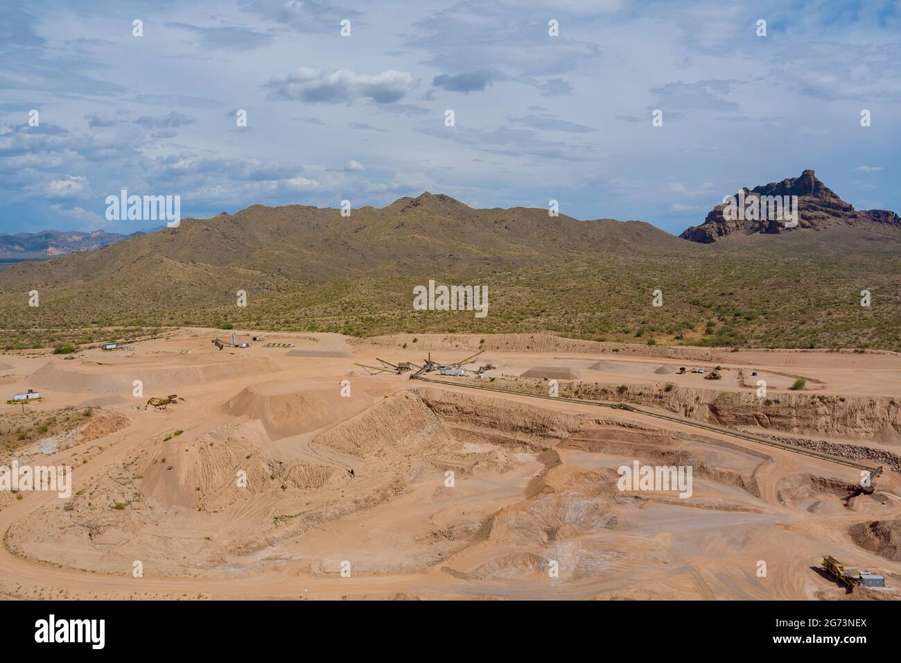 Over an open pit opencast mine and mining industry in Arizona desert