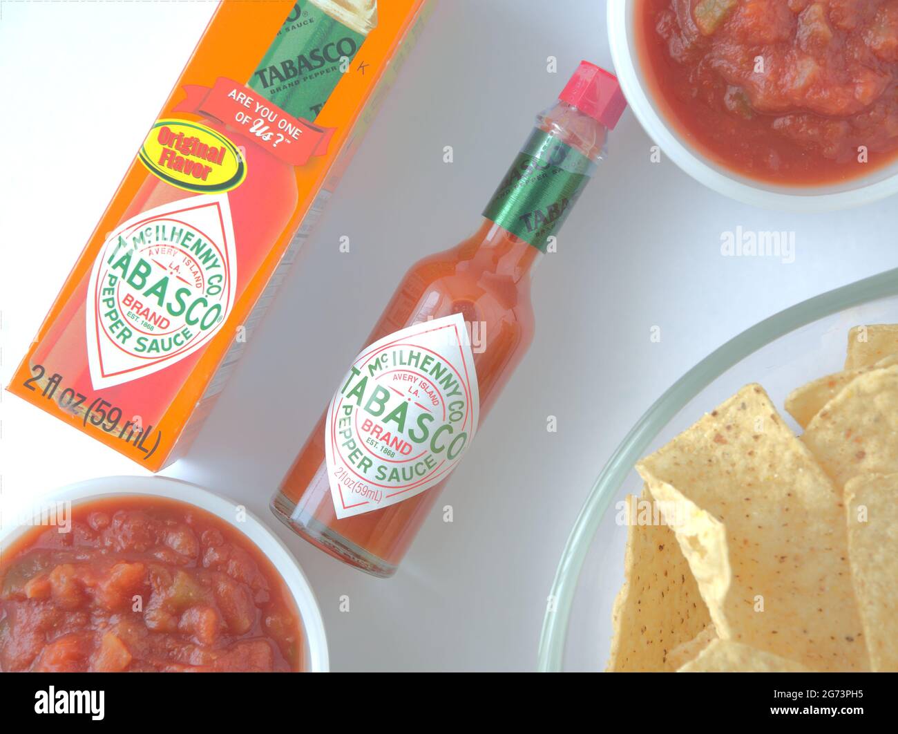 flat lay Red Tabasco Sauce bottle and two bowls of salsa and bowl of ...
