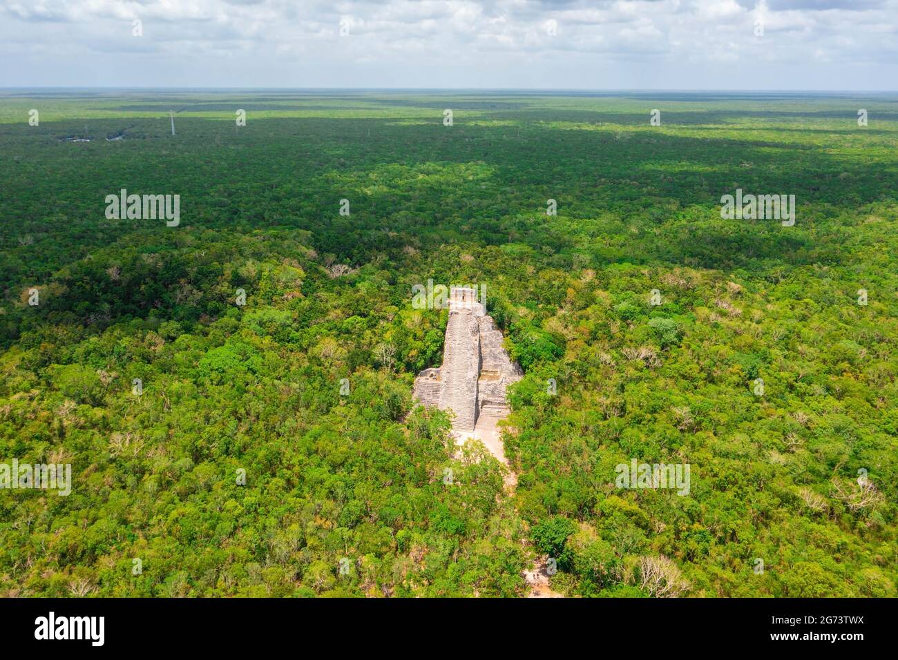 Aerial view of the Maya pyramid lost in the middle of a jungle. Stock Photo