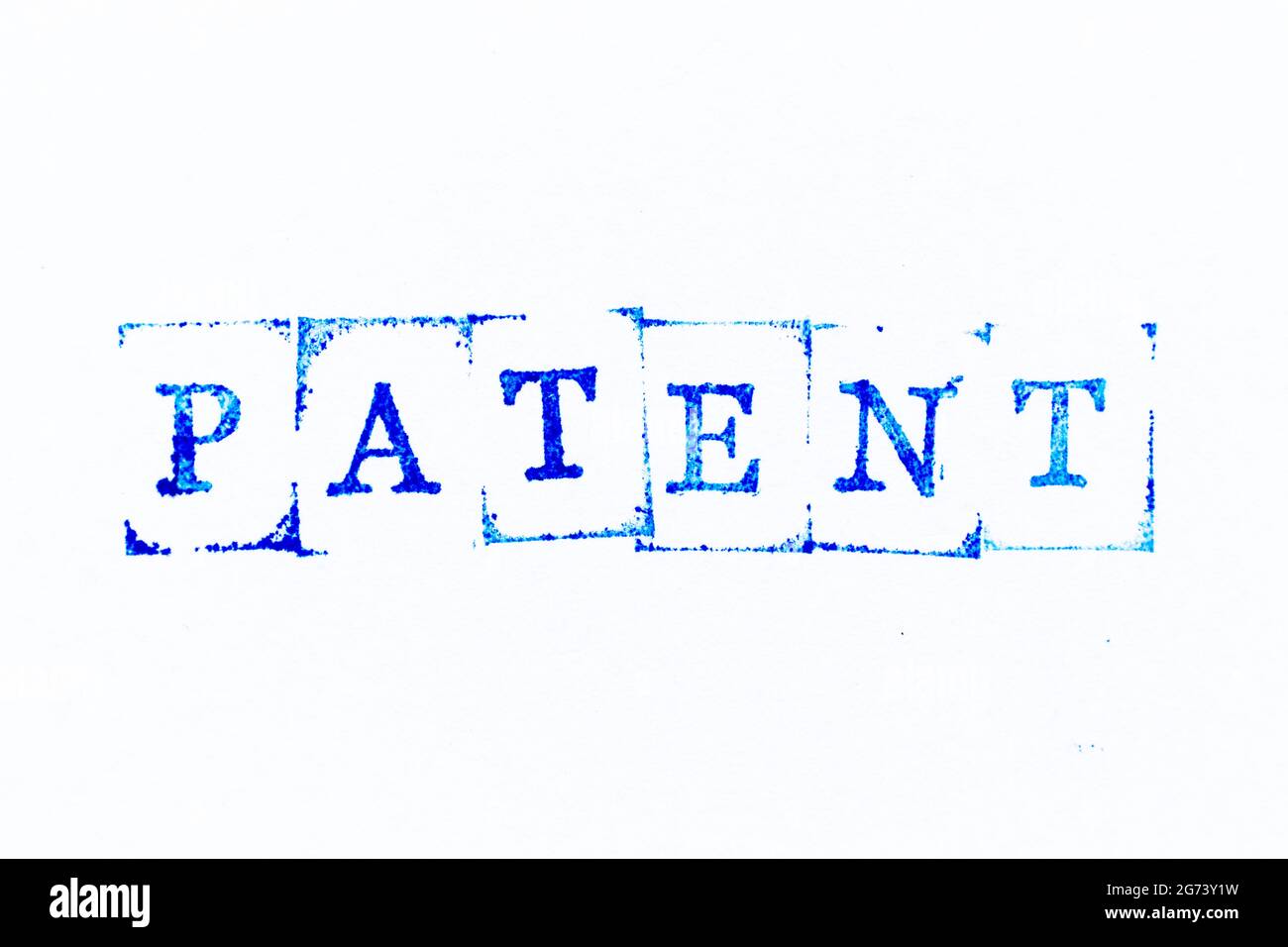 Blue color ink rubber stamp in word patent on white paper background Stock Photo