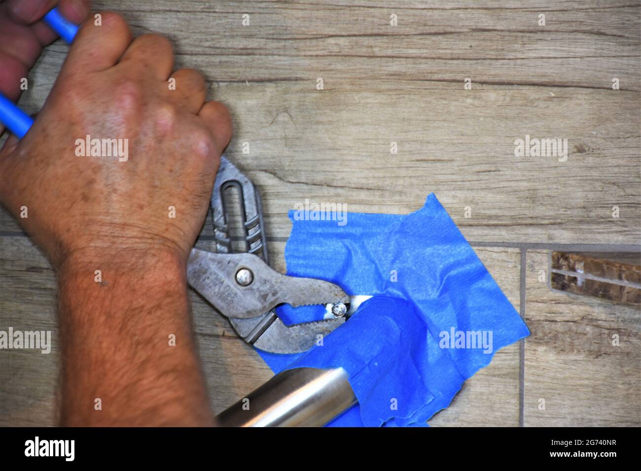 Installing handle in new shower wall Stock Photo Alamy