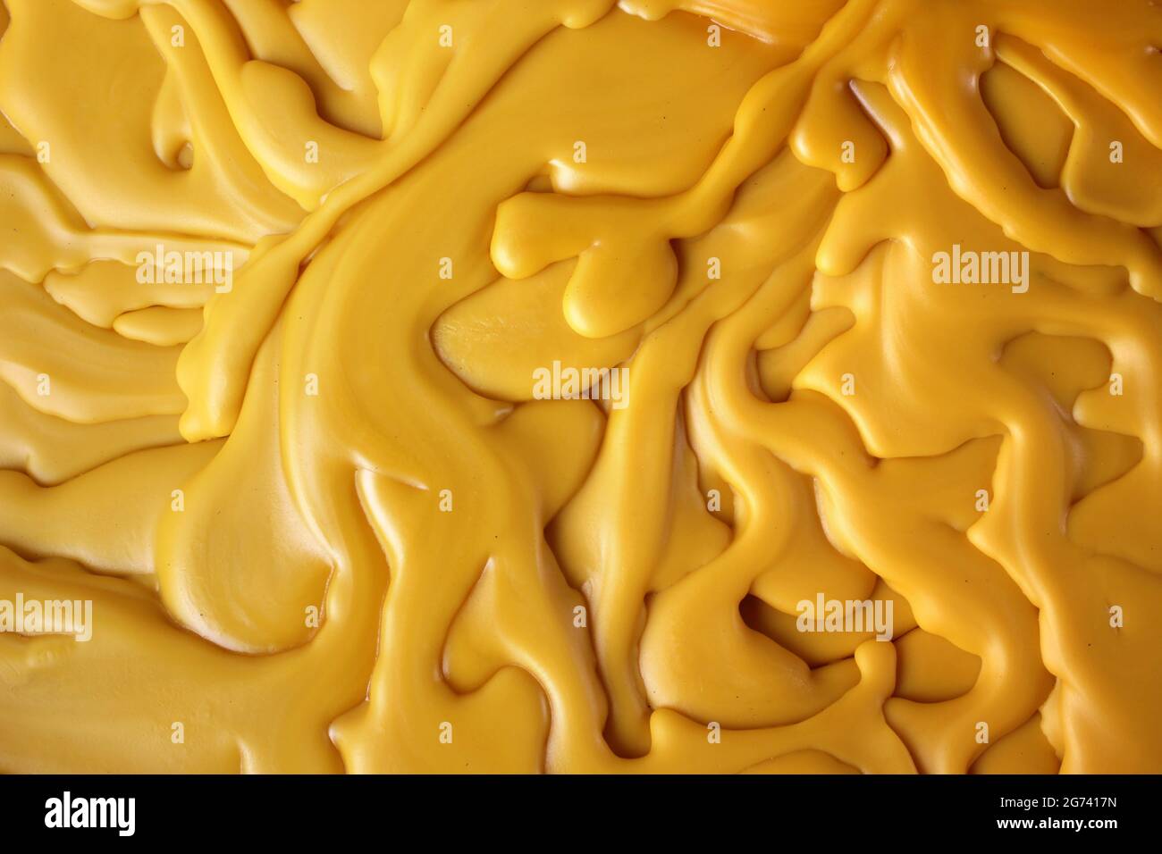 melting candles, yellow candle drippings as background Stock Photo
