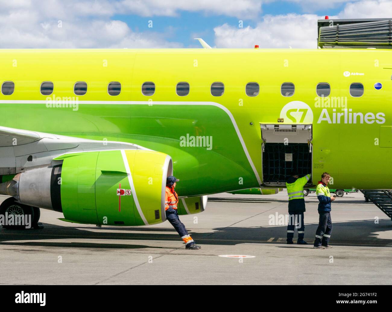 airport-personnel-sits-in-an-s7-airlines-airplane-jet-engine-with-his