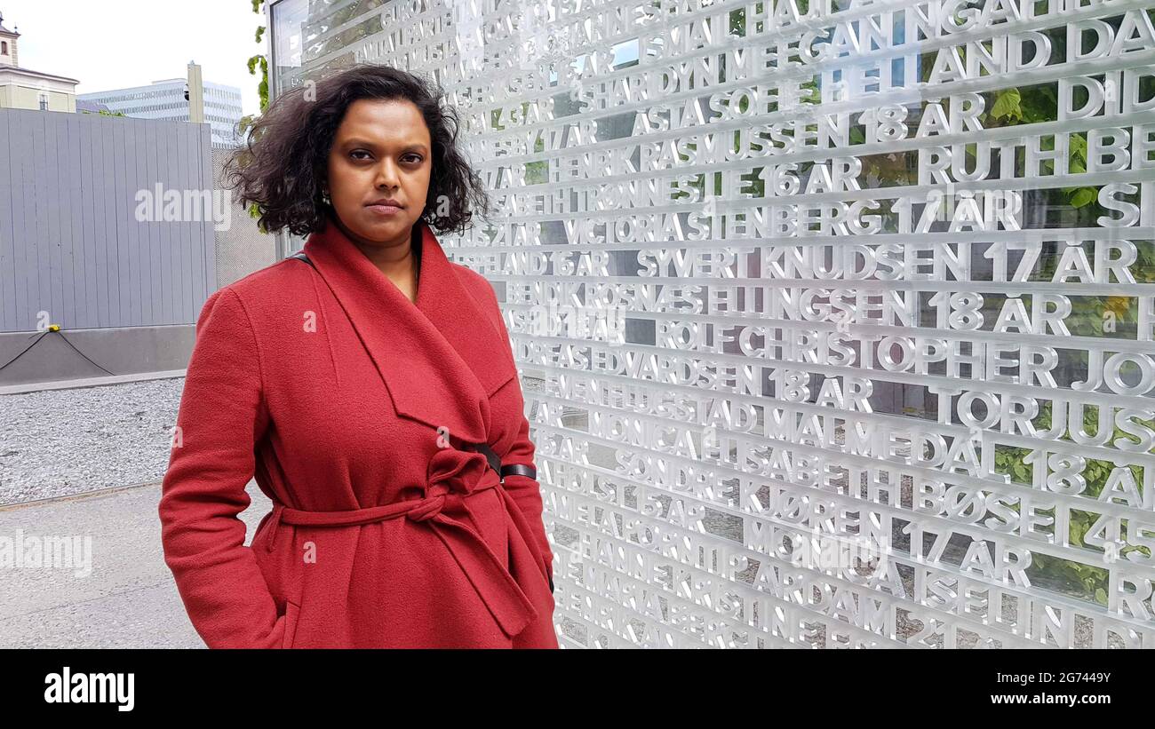 Oslo, Norway. 09th July, 2021. Kamzy Gunaratnam, deputy mayor of Oslo who survived the attack on Utøya, stands next to a monument in the government district with the names of the 77 people killed in the two attacks carried out by Norwegian terrorist Anders Behring Breivik. It has been 10 years since Breivik killed a total of 77 people in Oslo and on the island of Utøya. The police have learned from their mistakes, but society is only now beginning to come to terms with them. (to dpa ''Never again July 22' - Norway's response to terror') Credit: Sigrid Harms/dpa/Alamy Live News Stock Photo