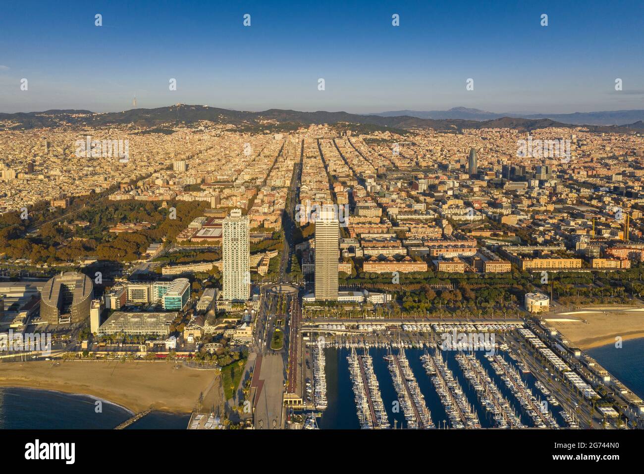 Aerial view of Torres Mapfre (twin towers) and the Olympic Port in the Vila Olímpica district, in Barcelona, at sunrise (Barcelona, Catalonia, Spain) Stock Photo