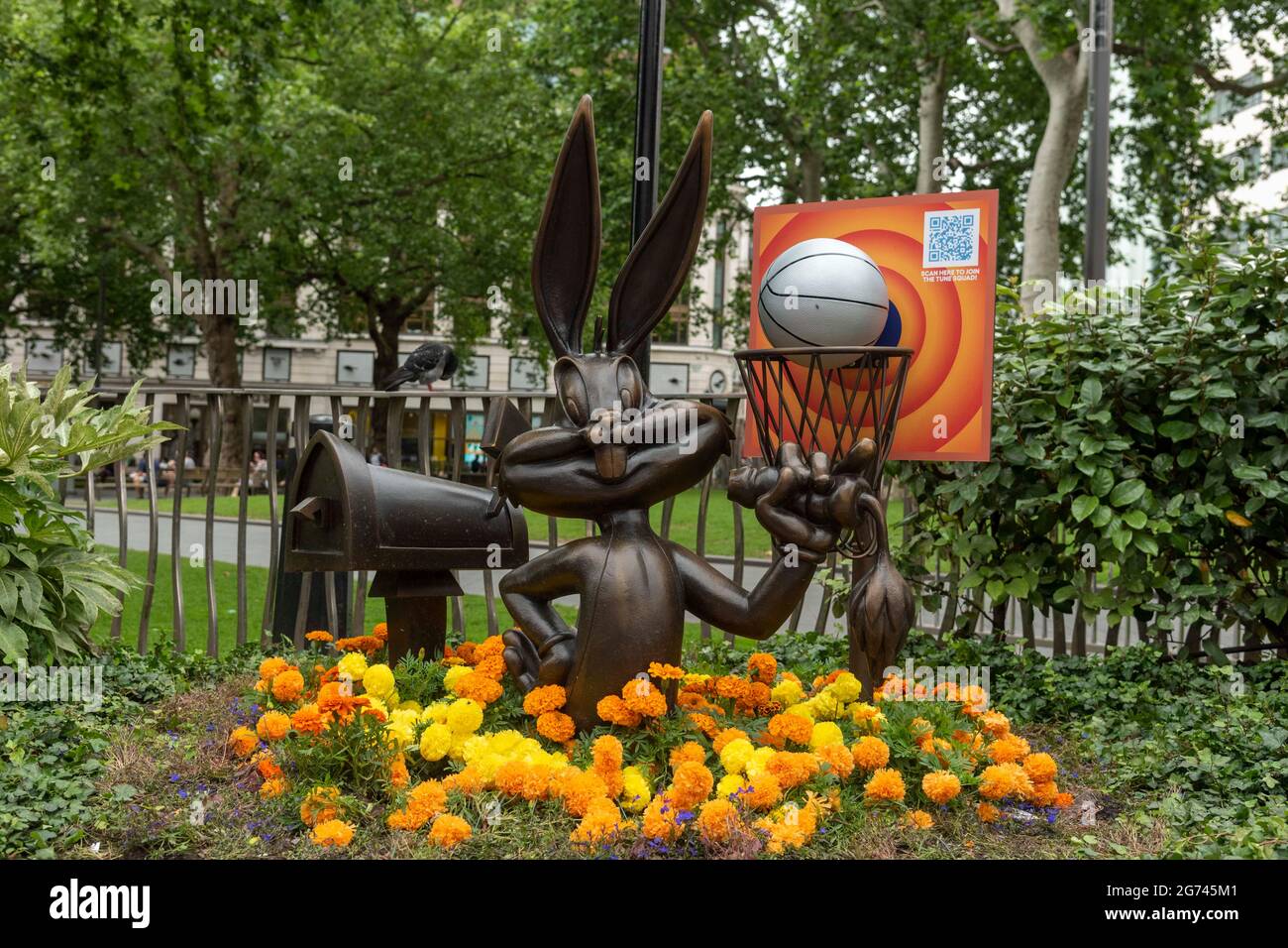 London, UK. 10th July, 2021. The Bugs Bunny statue in Leicester Square, part of the long-term Scenes in the Square sculpture trail now includes a life-sized basketball and hoop, along with a floral display in the colours of the Tune Squad to celebrate the release of Space Jam: A New Legacy in cinemas from the 16th July. (Photo by Dave Rushen/SOPA Images/Sipa USA) Credit: Sipa USA/Alamy Live News Stock Photo