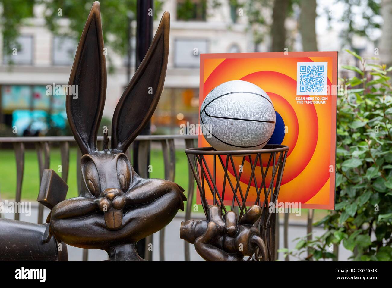 The Bugs Bunny statue in Leicester Square, part of the long-term Scenes in the Square sculpture trail now includes a life-sized basketball and hoop, along with a floral display in the colours of the Tune Squad to celebrate the release of Space Jam: A New Legacy in cinemas from the 16th July. (Photo by Dave Rushen / SOPA Images/Sipa USA) Stock Photo