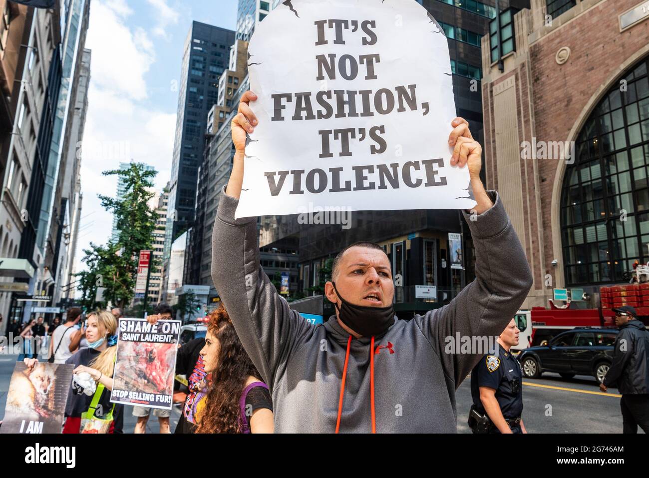Animal rights activists protest outside designer store Yves Saint Laurent in New York City on July 10 2021. The activists call on the luxury label to join Canada Goose and Saks Fifth