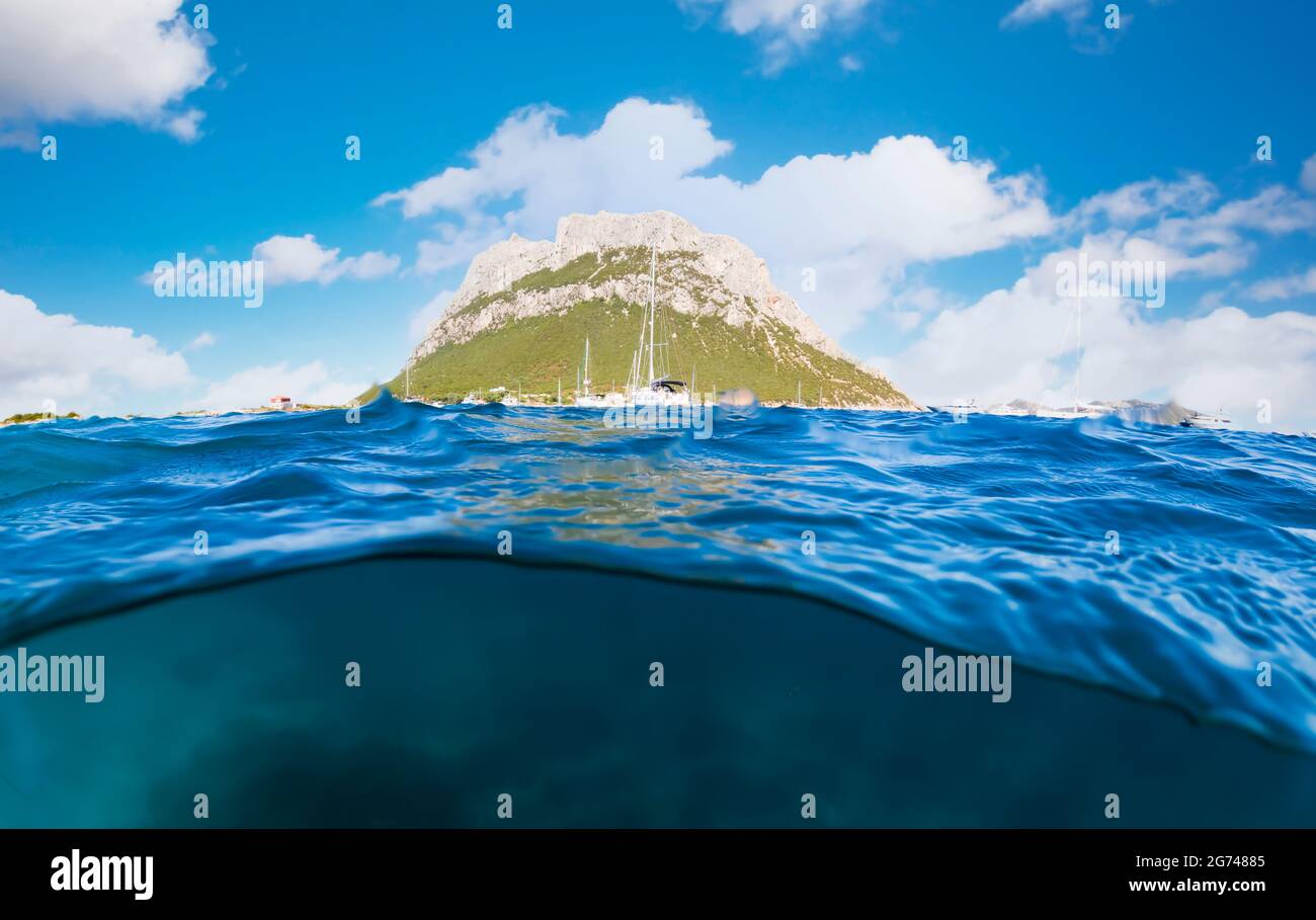 Split-shot, over-under shot. Half underwater half sky with Tavolara Island  in the distance during a sunny day. Sardinia, Italy Stock Photo - Alamy