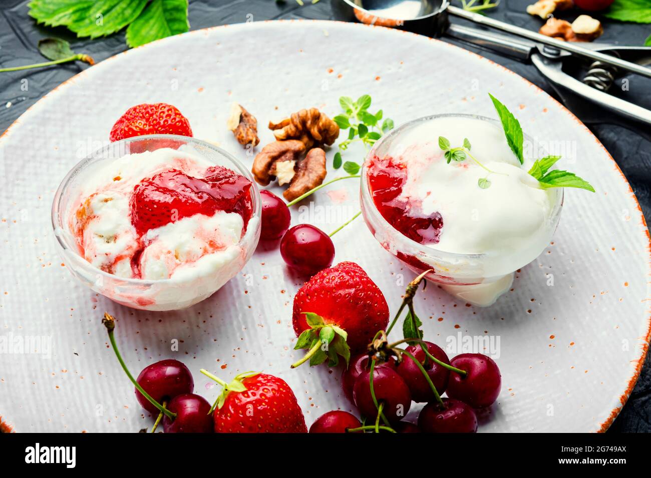 Summer dessert, ice cream with strawberries and cherries.Ice cream with berry jam Stock Photo