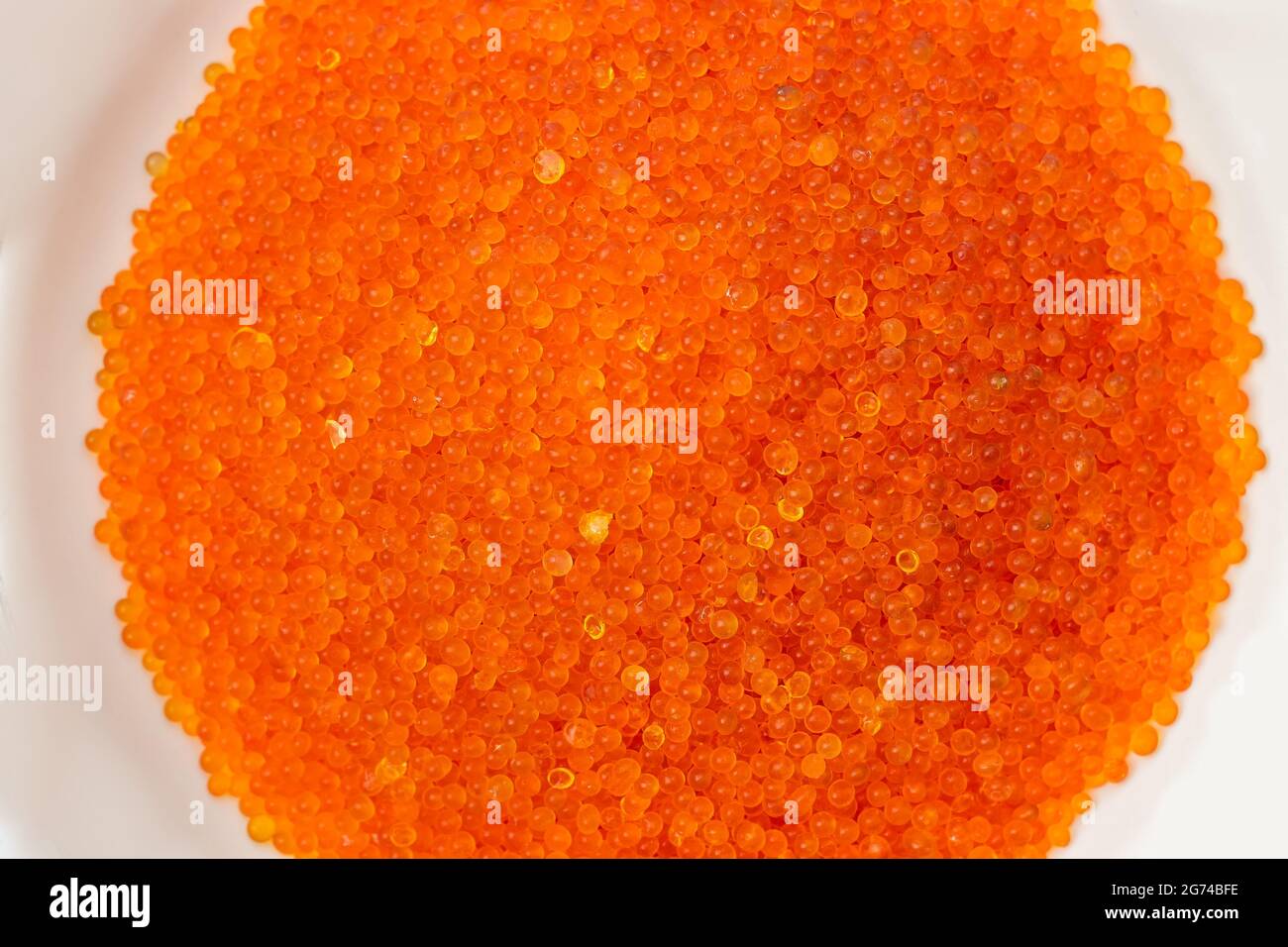 Close up of hand holding blue silica gel on white background, Granular Desiccant attract